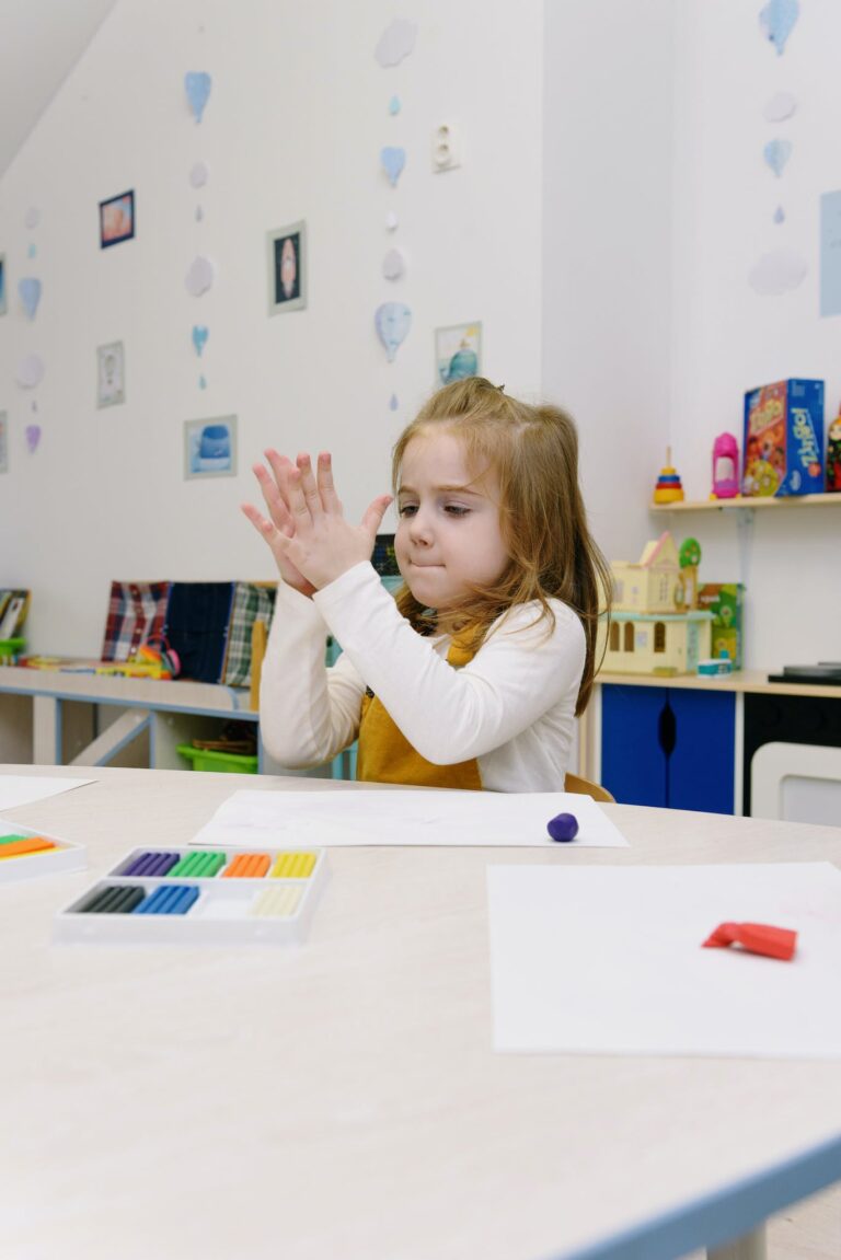 Girl Sculpting of Modeling Clay While Sitting at Table